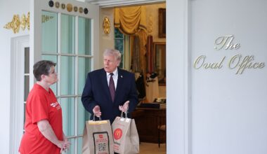 President Donald Trump receives a DoorDash delivery at the Oval Office from Sharon Simmons (Win McNamee/Getty Images)