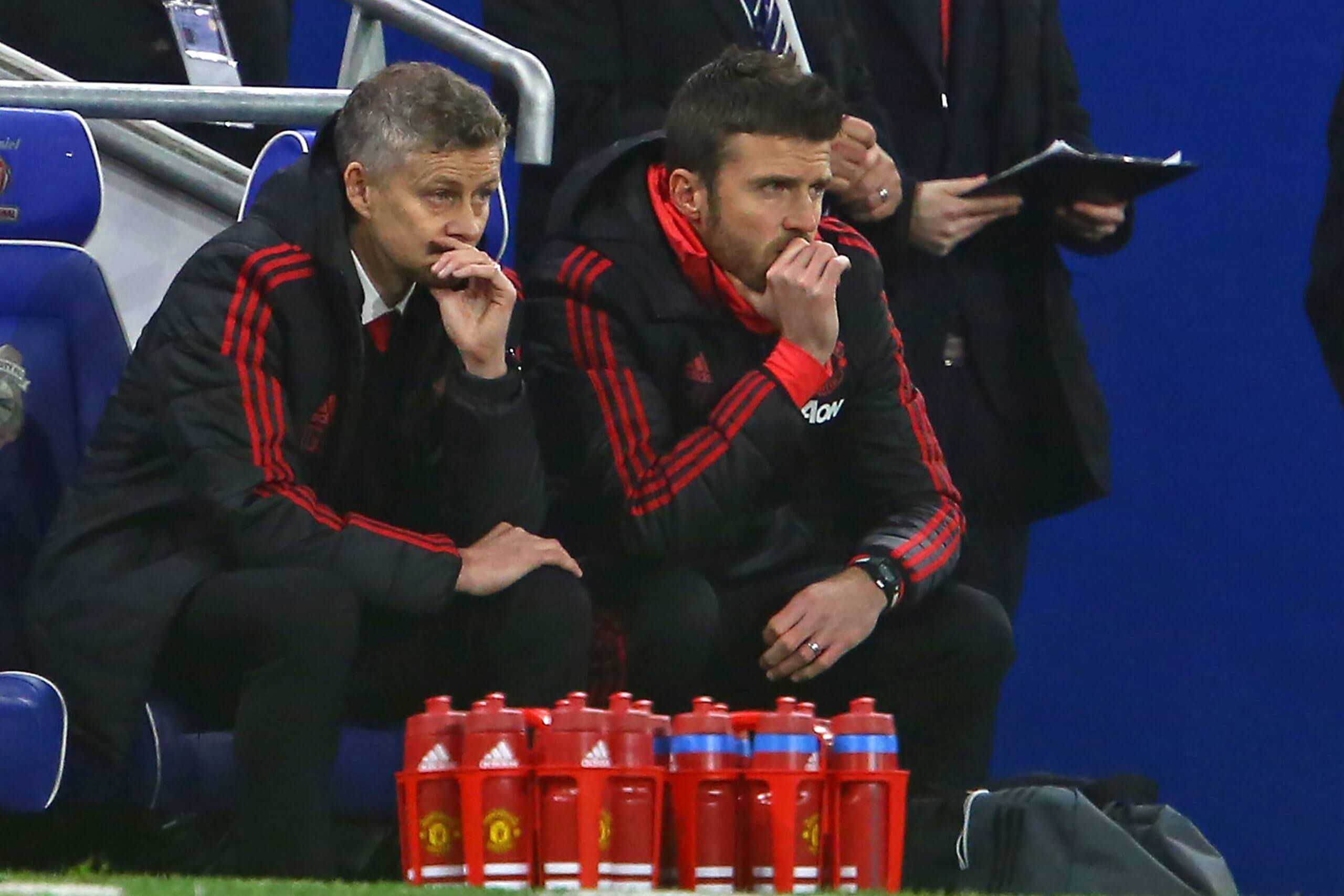 Ole Gunnar Solskjaer and Michael Carrick watch from their seats during the Premier League match between between Cardiff City and Manchester United