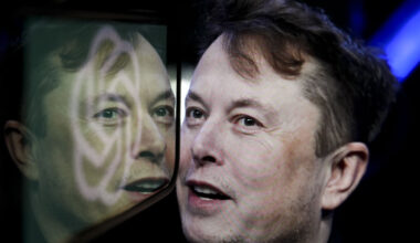 In this photo illustration, the logo of 'OpenAI' is displayed on a mobile phone screen in front of a computer screen displaying the photograph of Elon Musk.