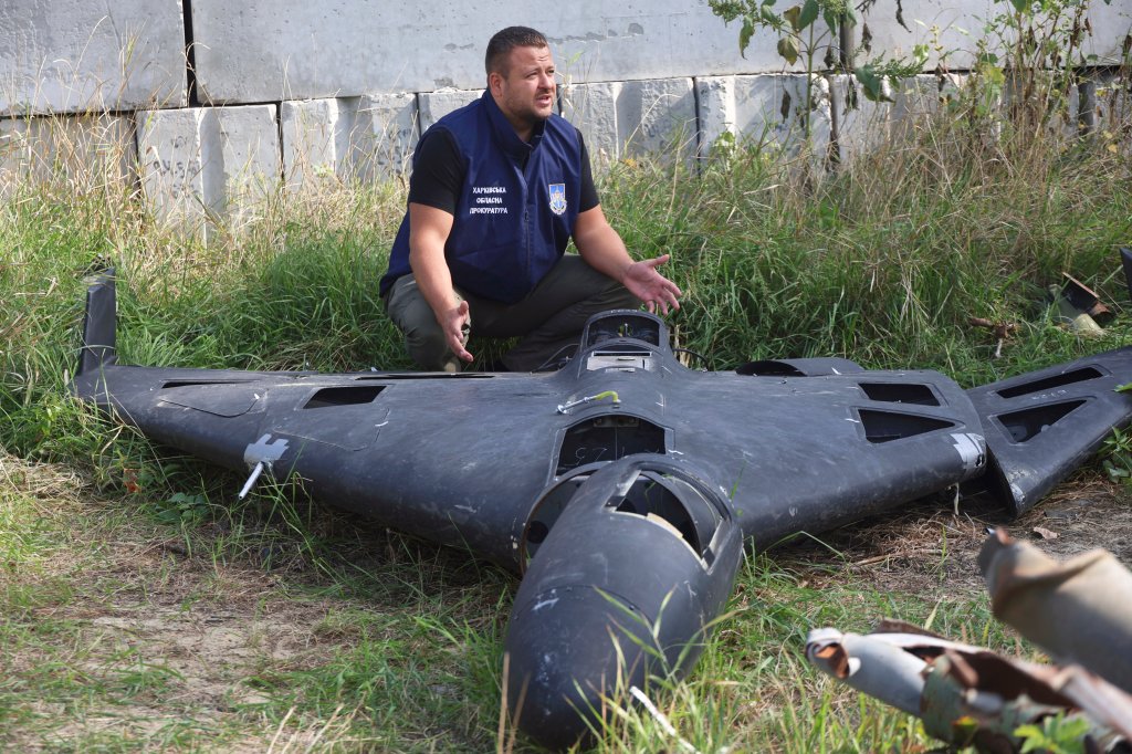 An employee of the Kharkiv Regional Prosecutor's Office of Ukraine squats by a fragment of a Shahed drone found at the site of a Russian strike in Kharkiv, Ukraine, on September 19, 2025 (Photo by Viacheslav Madiievskyi/Ukrinform/NurPhoto via Getty Images). NO USE RUSSIA. NO USE BELARUS. (Photo by Ukrinform/NurPhoto via Getty Images)