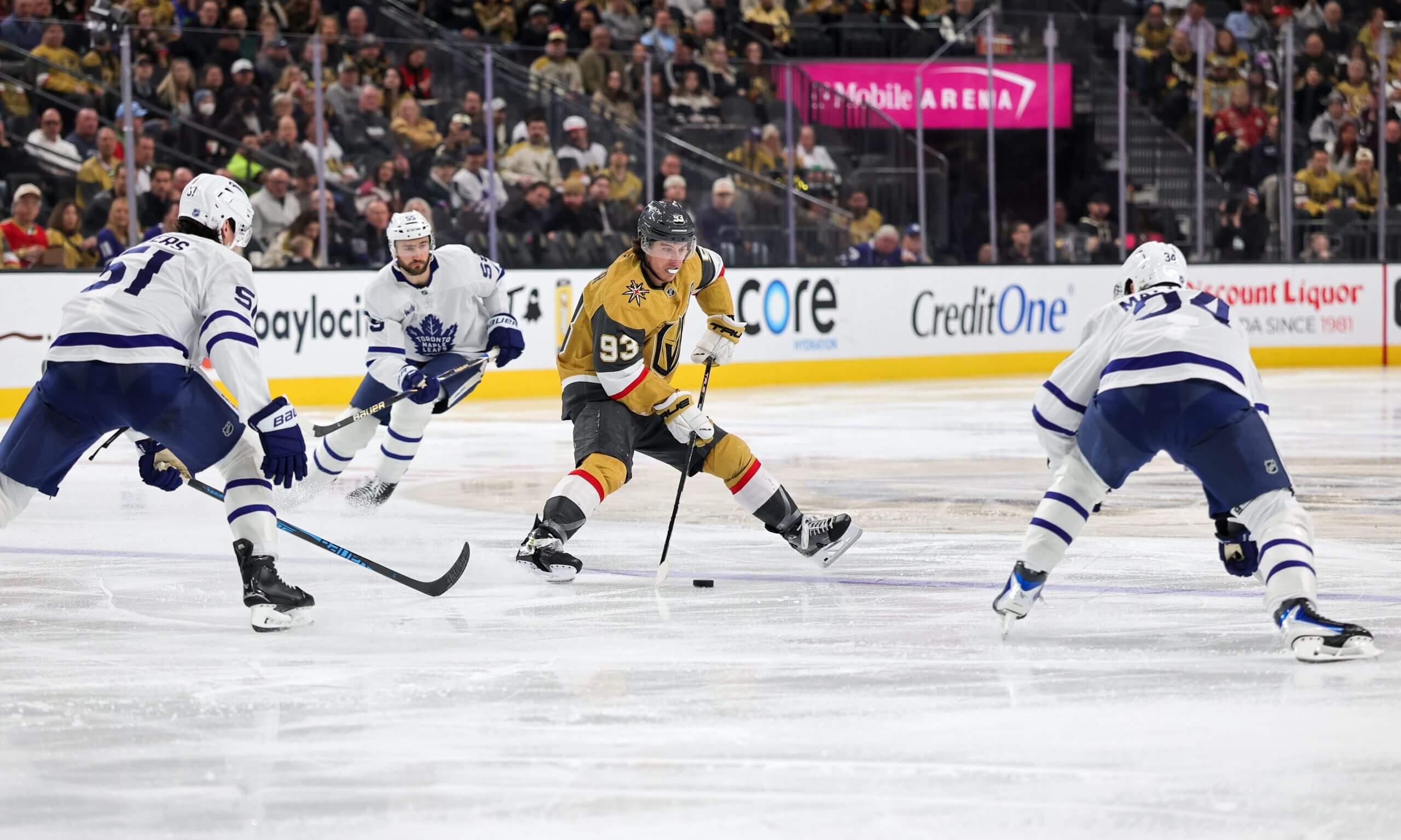 Mitch Marner controls the puck with three Leafs players closing in.