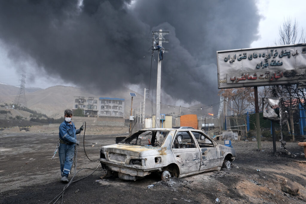 Plumes of smoke rise over the oil depot tanks hit by overnight attacks on March 8 in Tehran, Iran. Credit: Kaveh Kazemi/Getty Images
