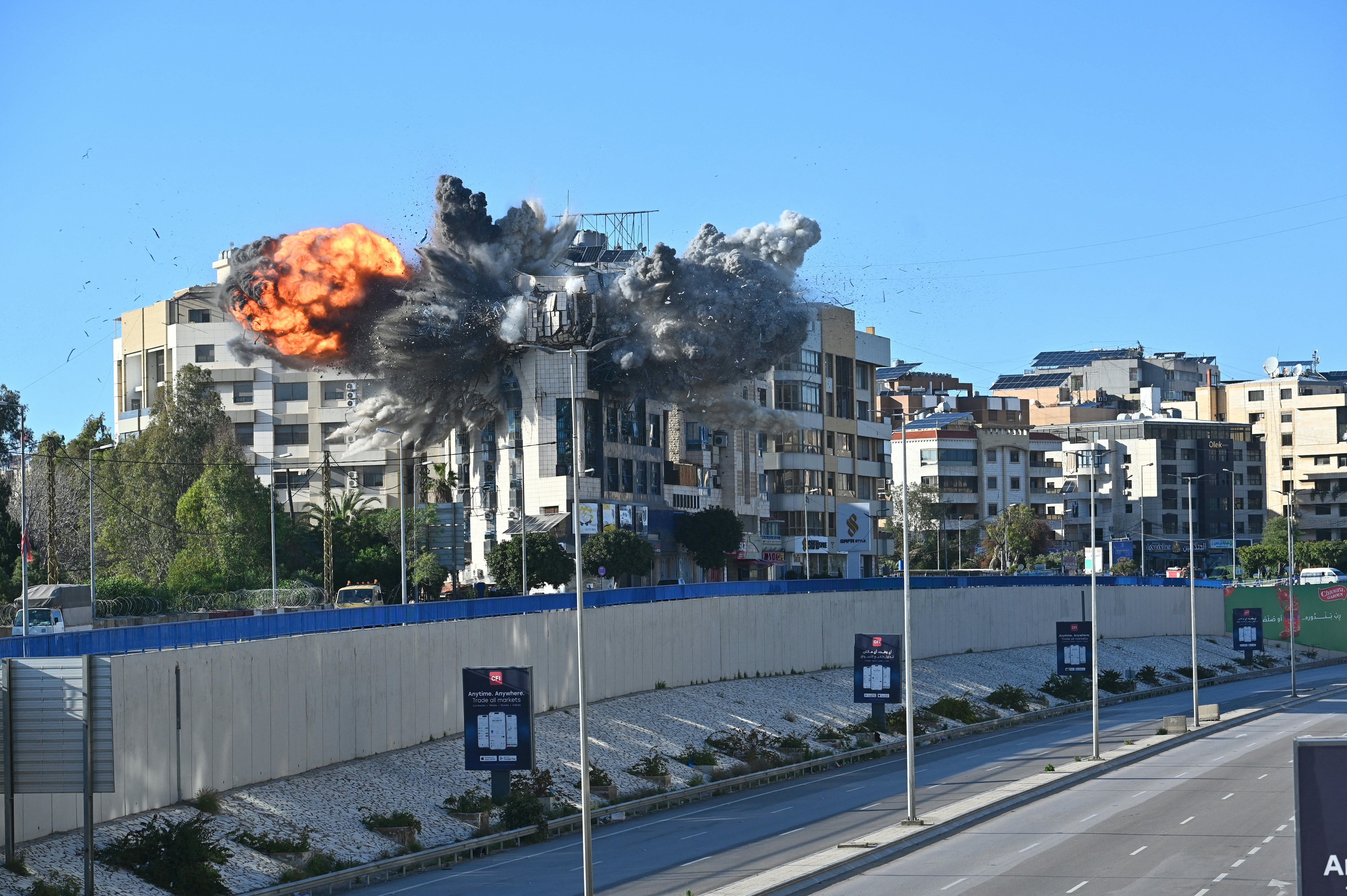 A ball of fire rises from the site of an Israeli strike that targeted a building adjacent to the highway that leads to Beirut's international airport