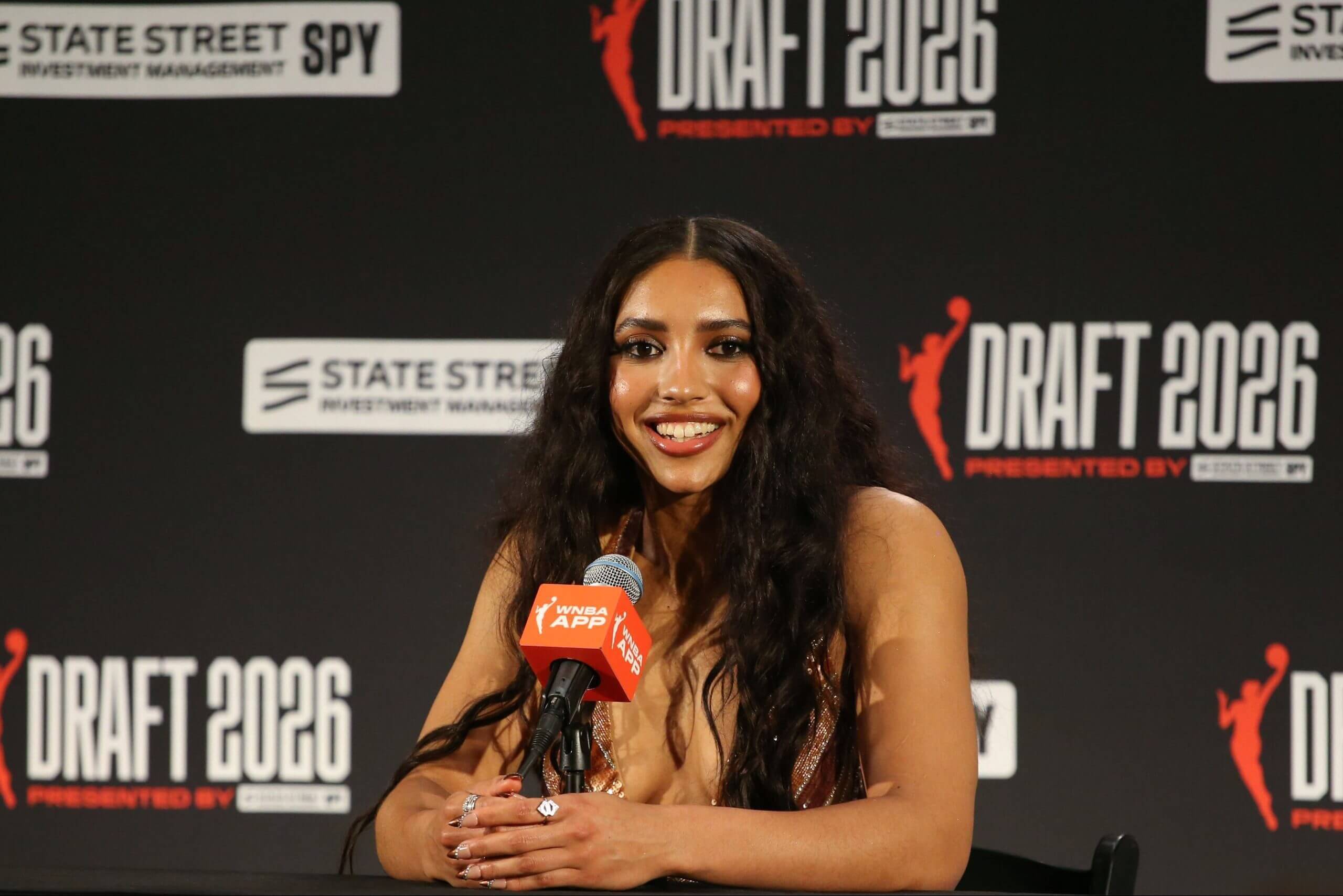 Azzi Fudd sits with a microphone in front of her as she speaks to reporters after being selected as the top draft pick.