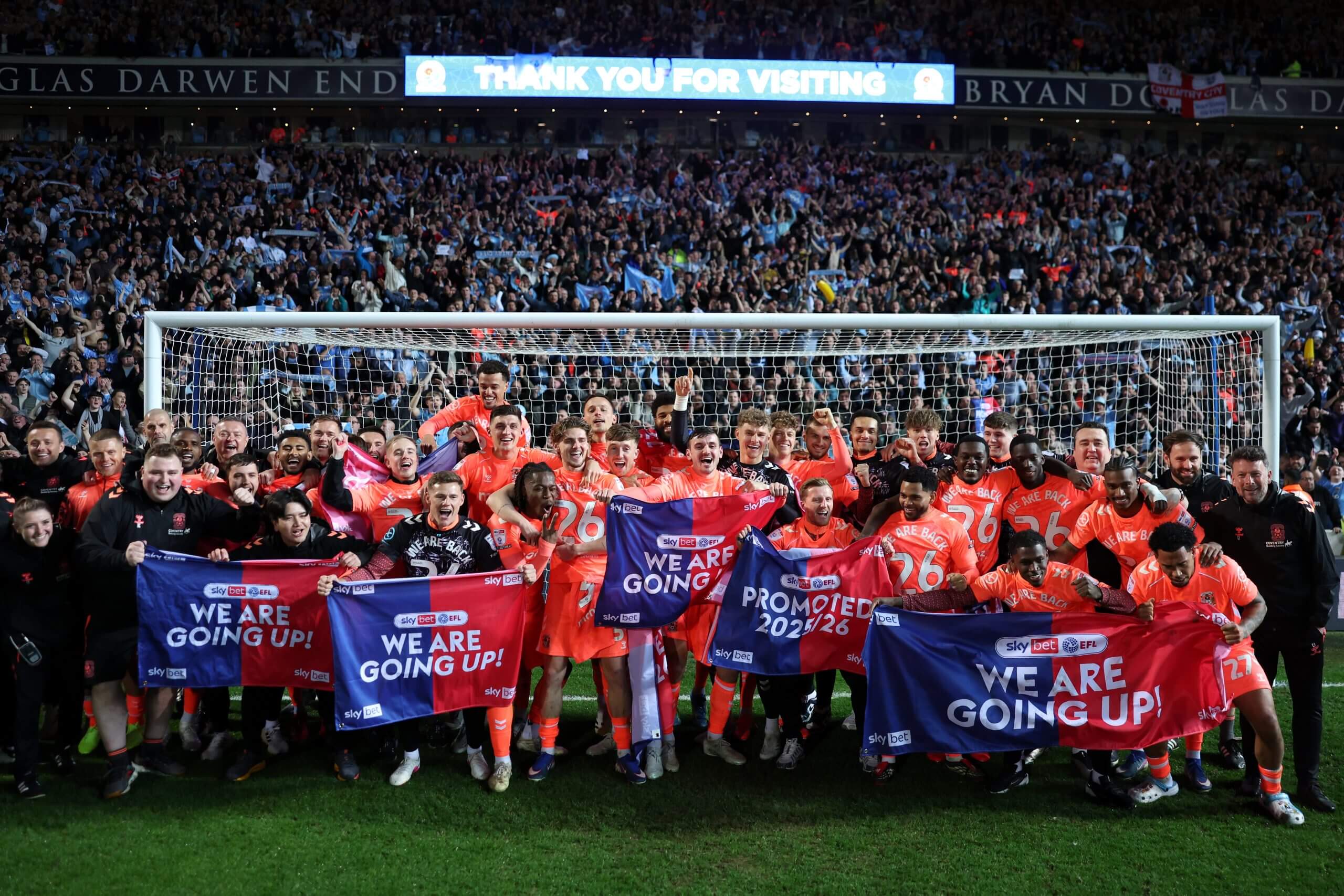 The Coventry City team pose for a photo as they celebrate their promotion following the 1-1 at Blackburn Rovers 