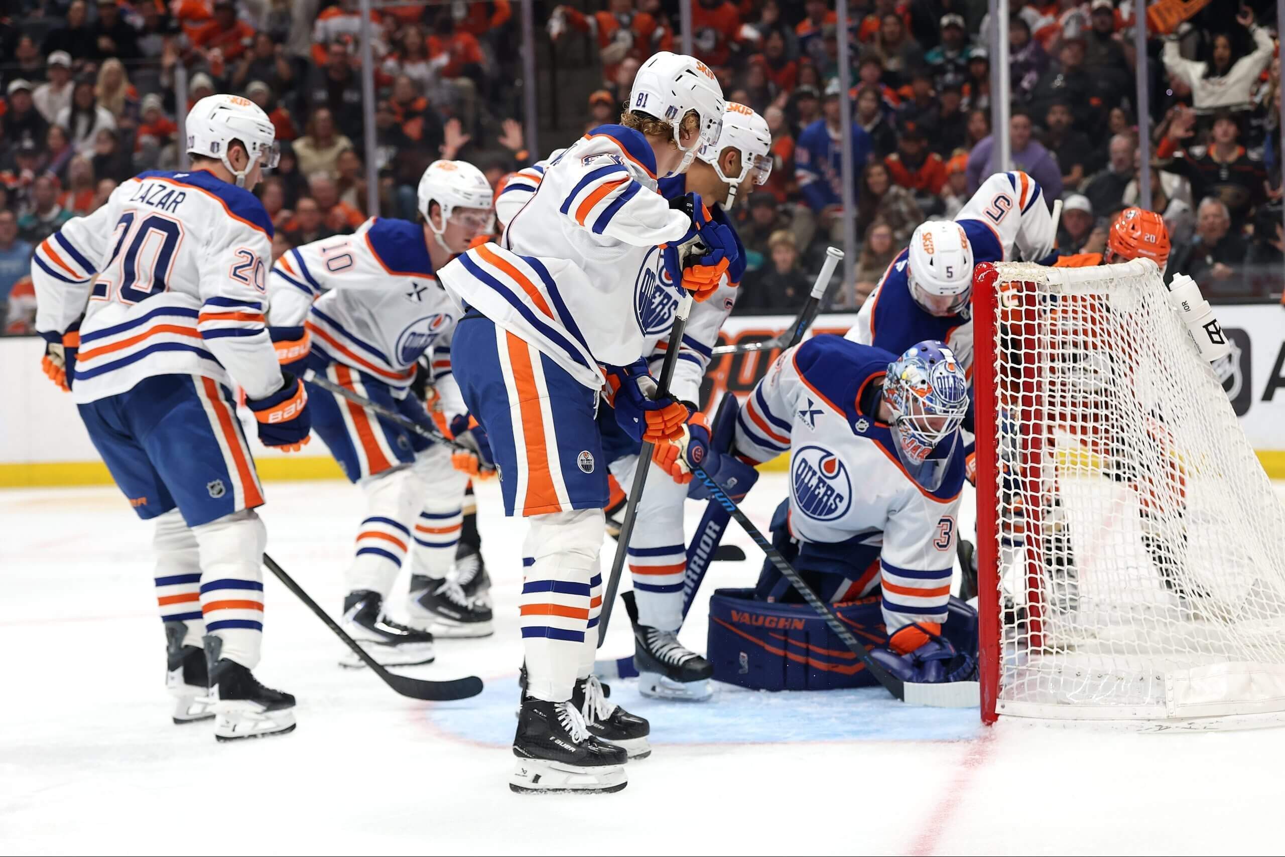 Oilers players look to see if a puck crossed the goal line in a playoff game against the Ducks.
