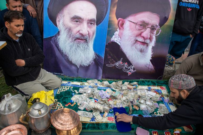 Cash donated for Iran at a collection drive in Indian-administered Kashmir [Junaid Bhat/ Al Jazeera]