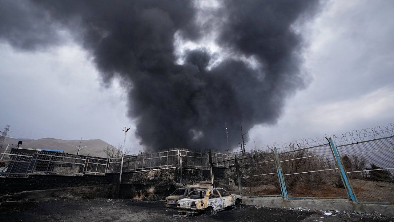 A thick plume of smoke rises from an oil storage facility hit by a U.S.-Israeli strike in Tehran, Iran, March 8, 2026.