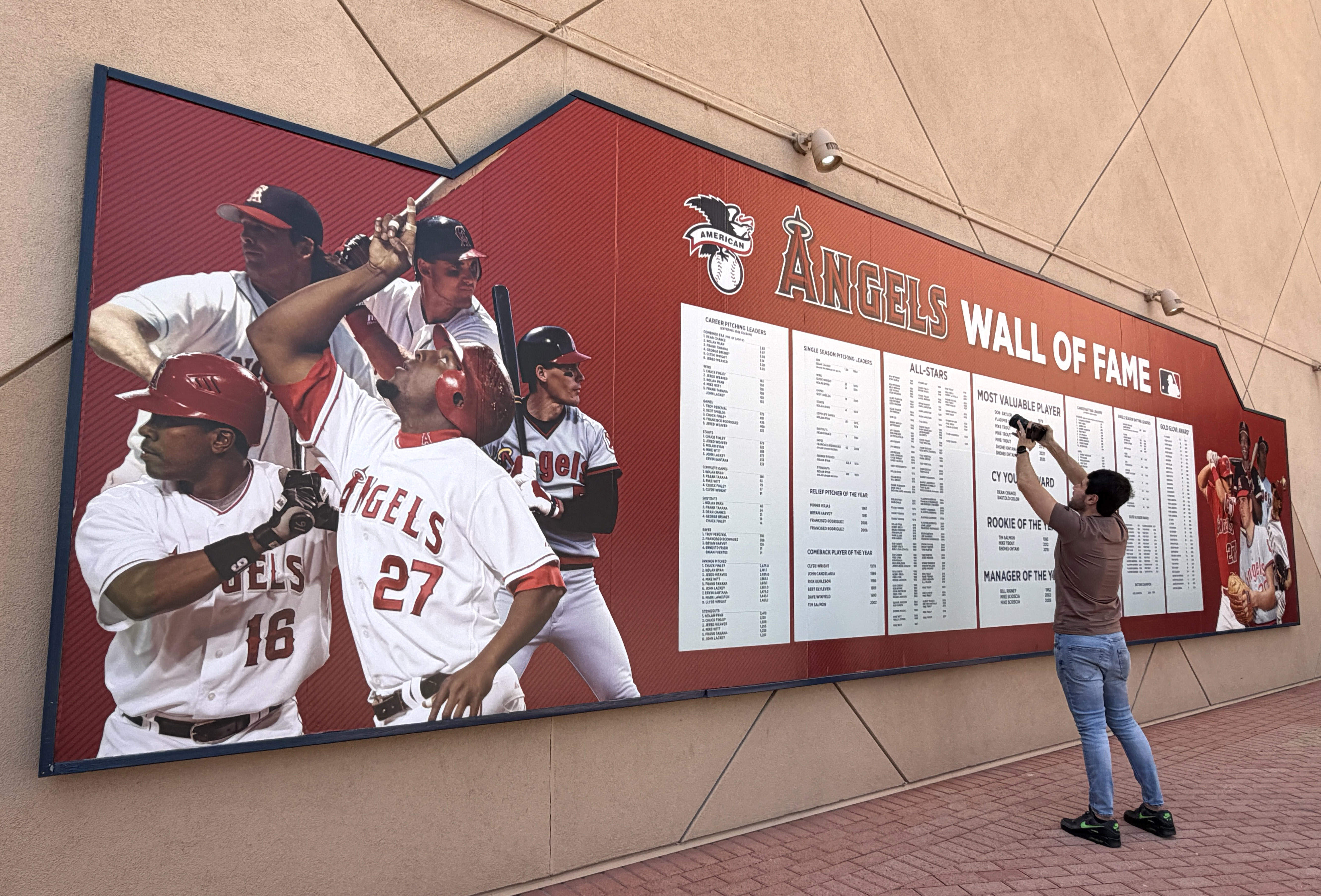 A man photographs the Angels Wall of Fame as Angel...