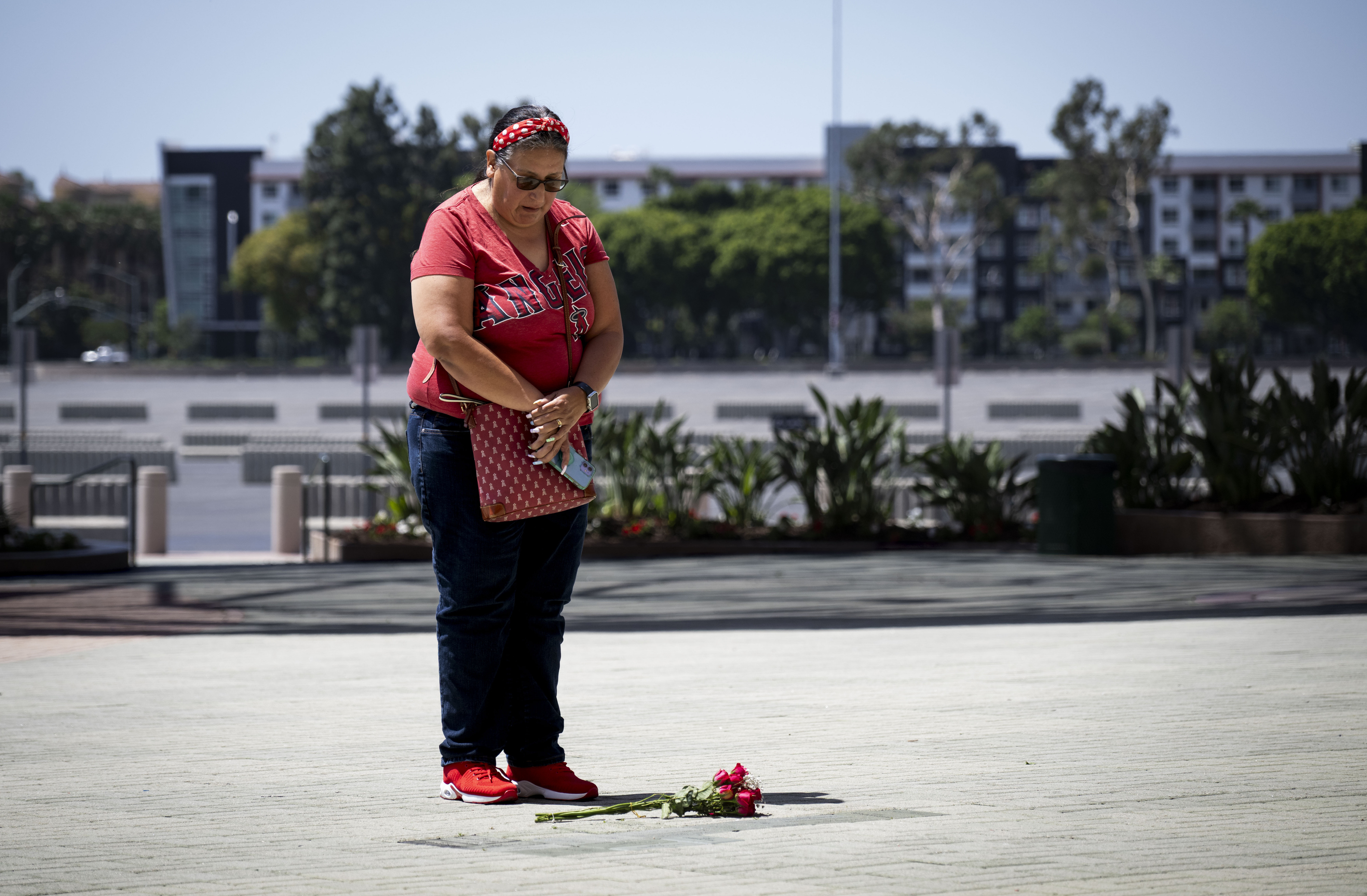 Patricia Raburn pauses outside Angel Stadium to pay respects to...