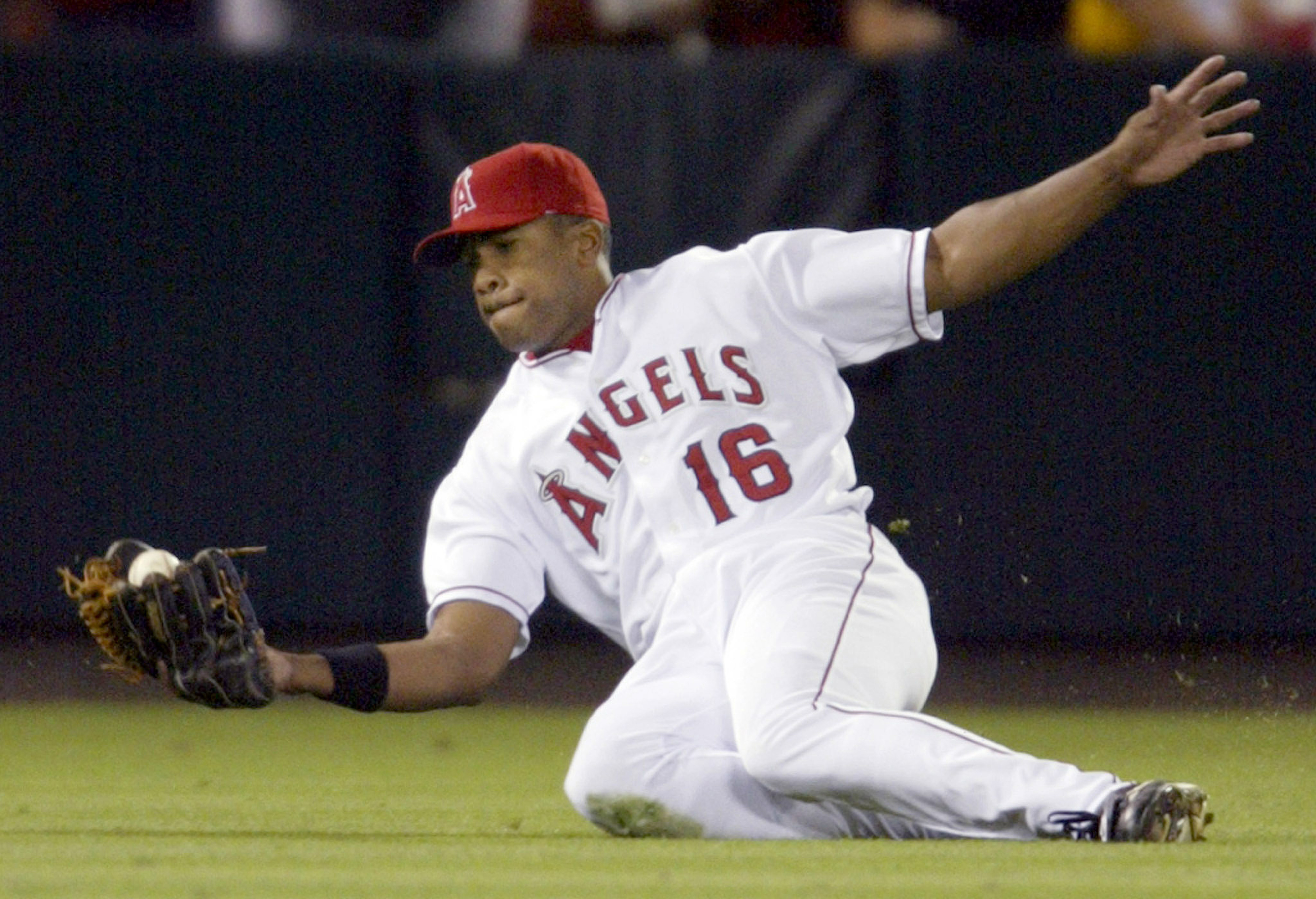 Garret Anderson (16) of the Angels makes a sliding catch...