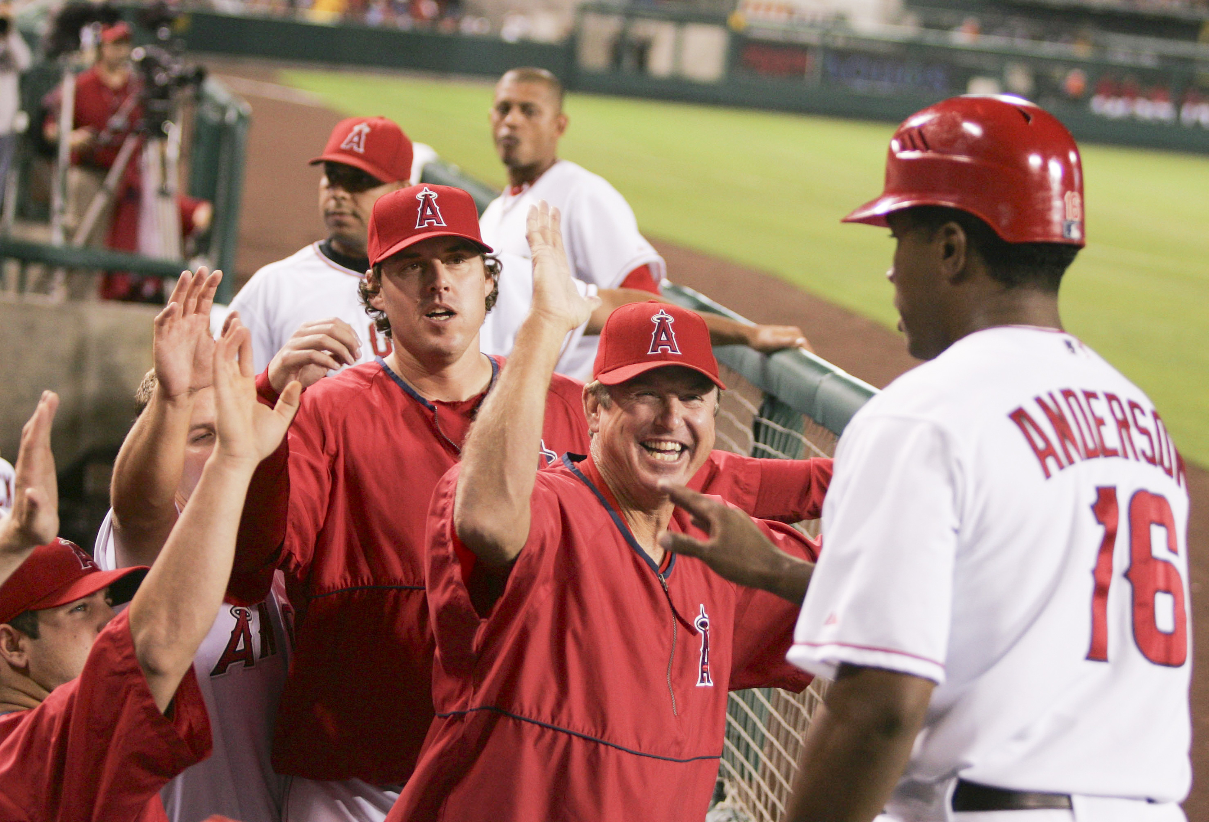 Mickey Hatcher of the Angels and teammates welcome Garret Anderson...