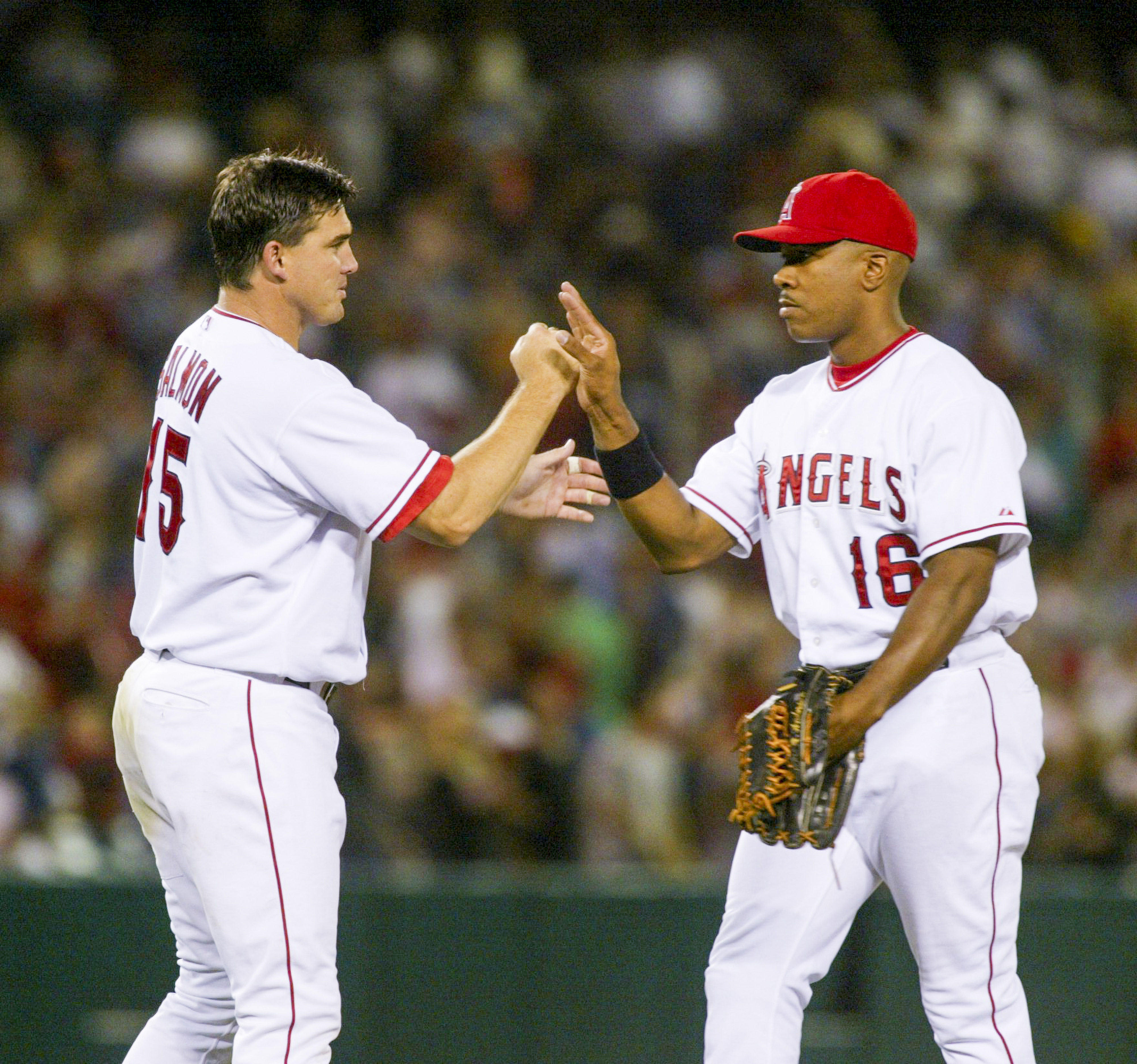 Tim Salmon, left, and Garret Anderson high-five after the Angels...