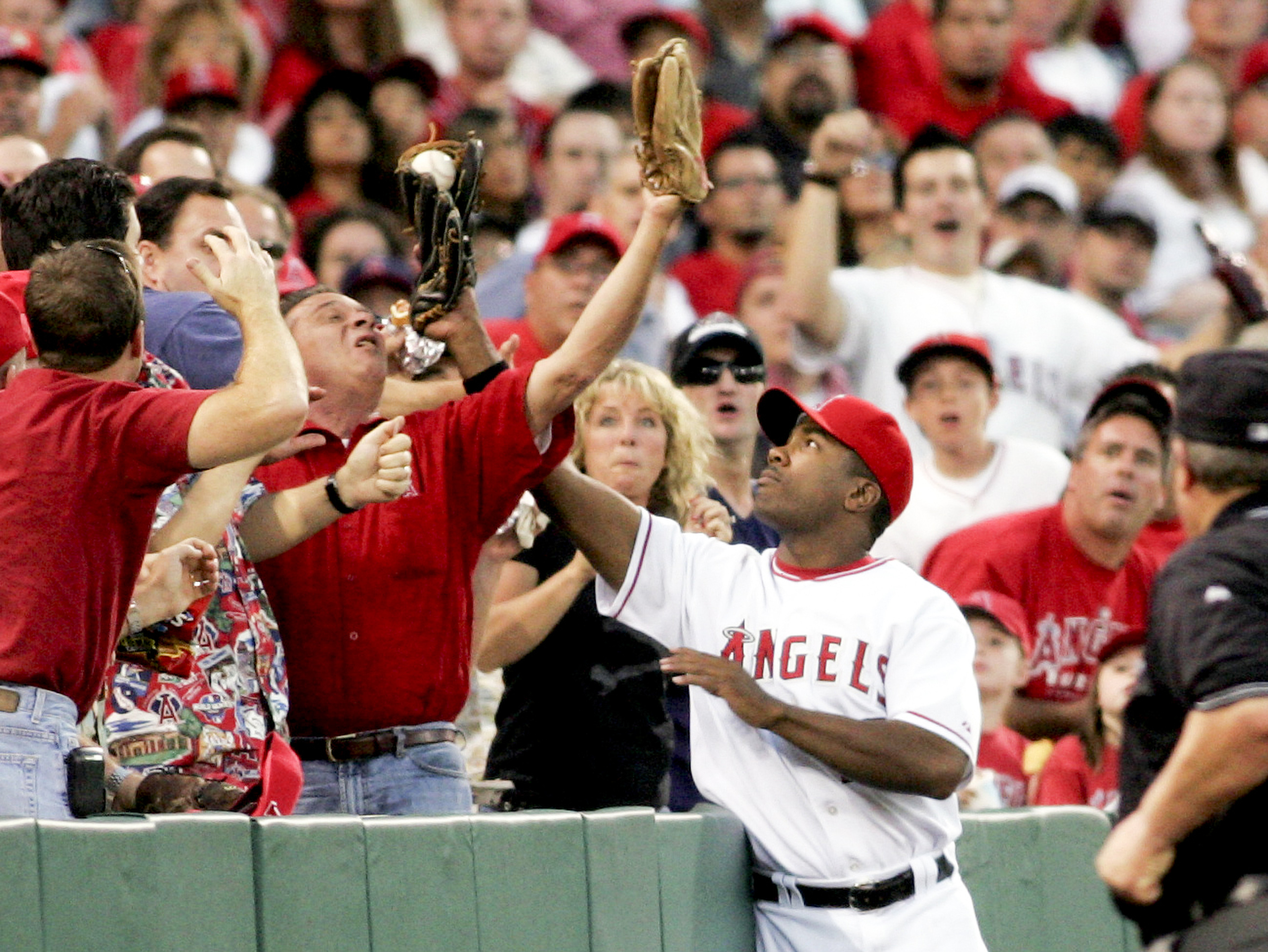 Garret Anderson of the Angels catches a fly ball in...