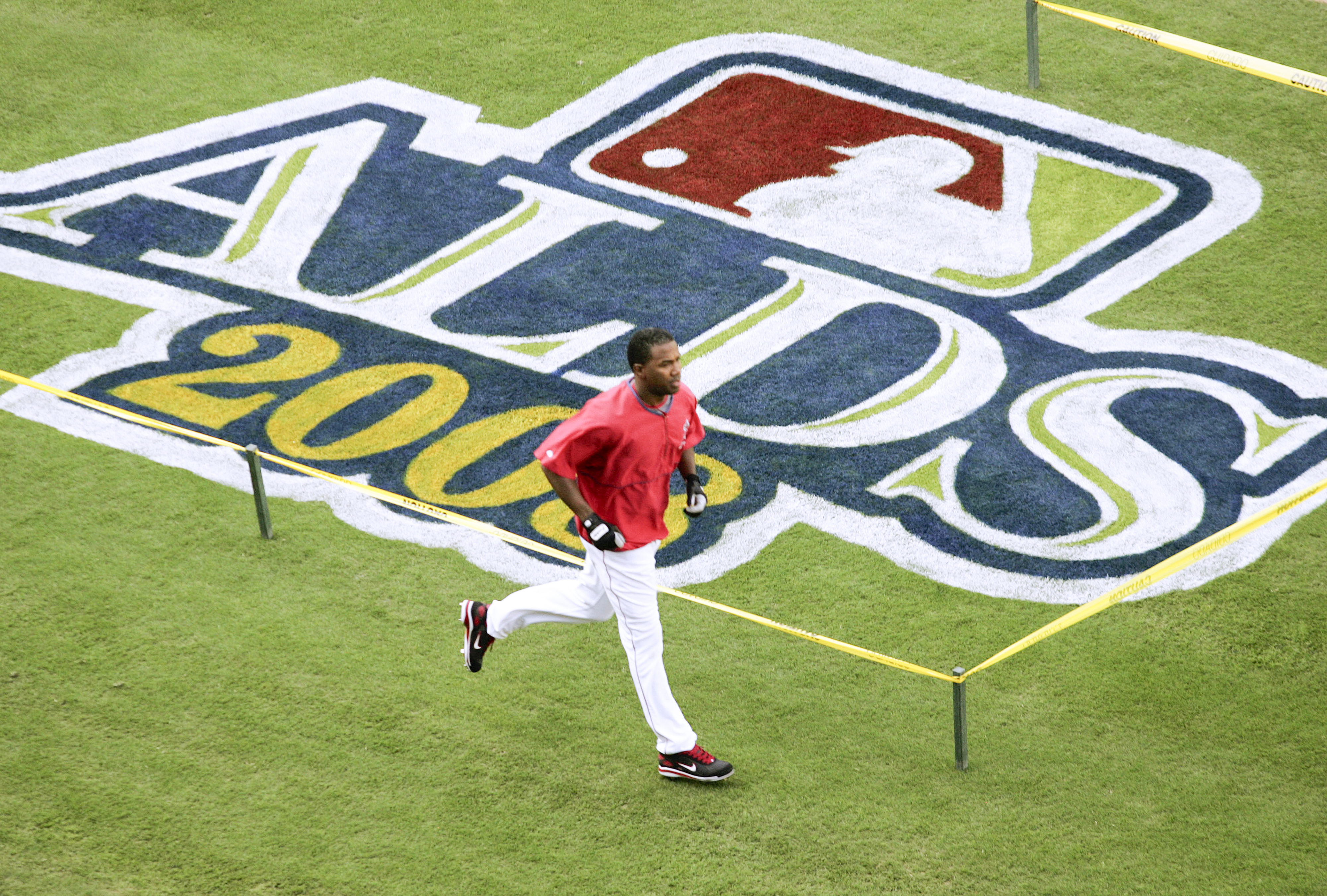 The Angels’ Garret Anderson runs by a freshly painted ALDS...
