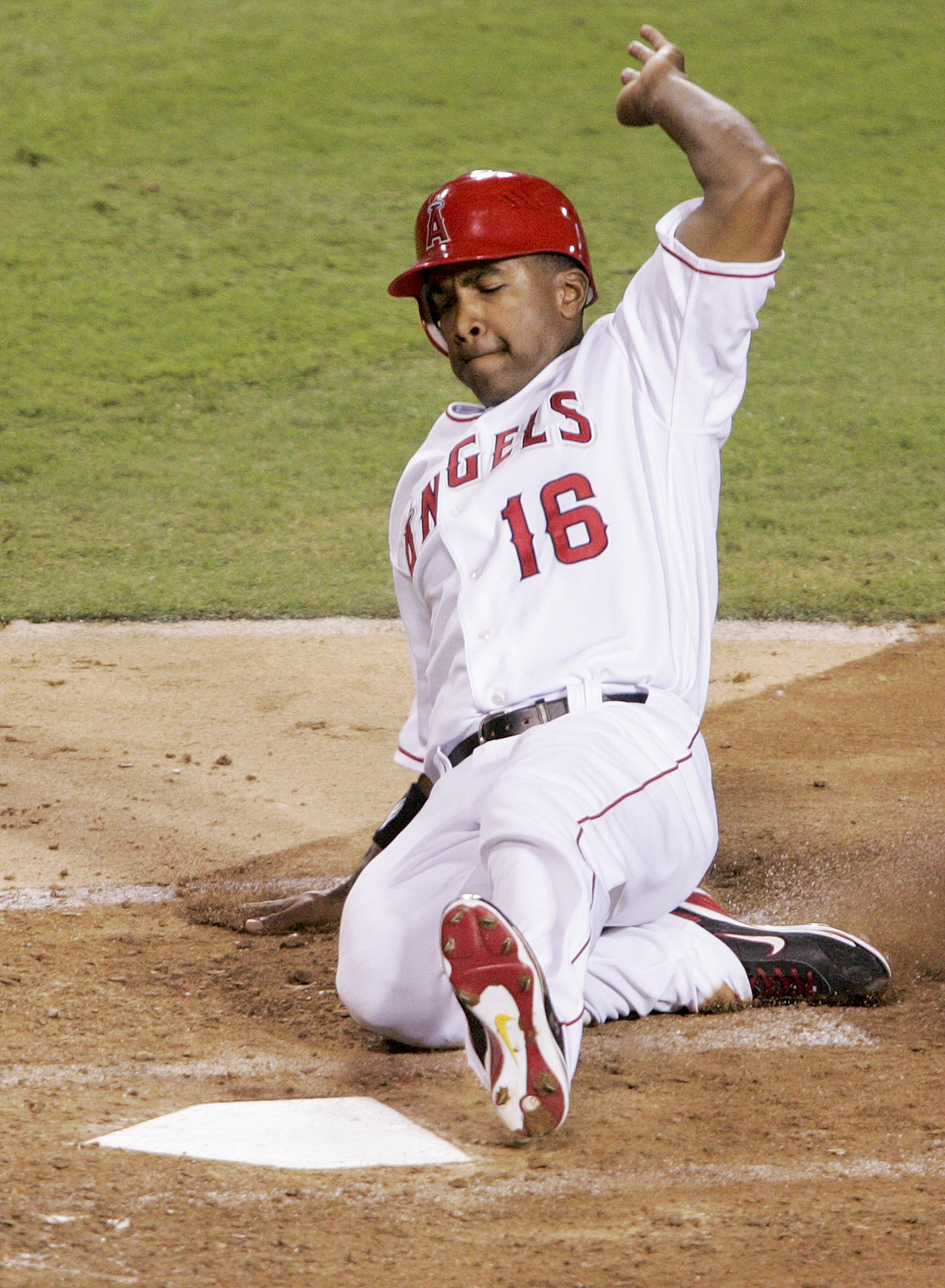 Garret Anderson (16) of the Angels scores after Torii Hunter...