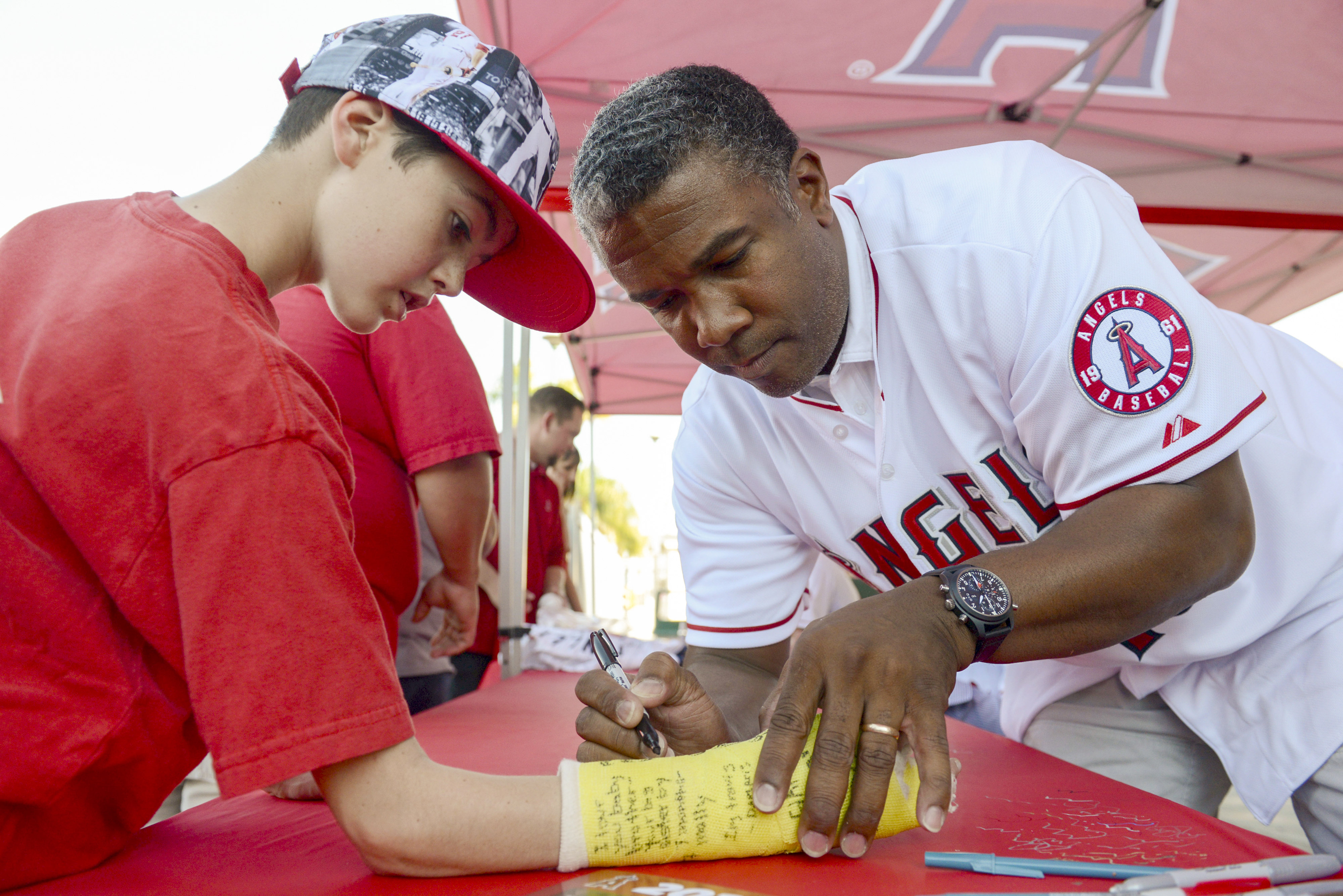Travis Ascheri, 13, of Long Beach, gets his cast signed...