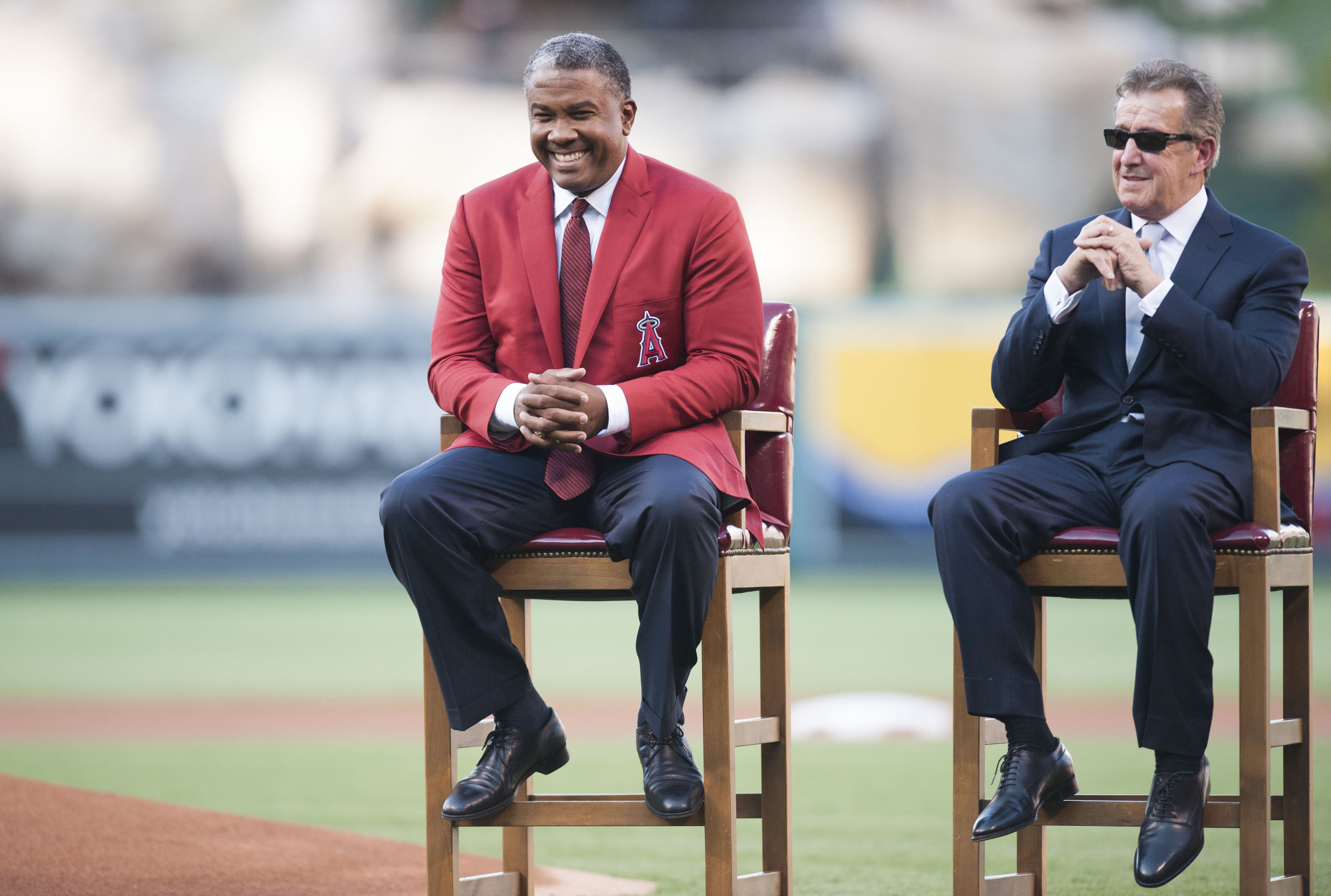 Former Angel Garret Anderson, left, laughs next to owner Arte...
