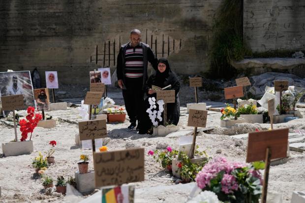 Zeinab Zeitoun and her husband, Mohammed Farran, visit family members' graves in Sidon, Lebanon.