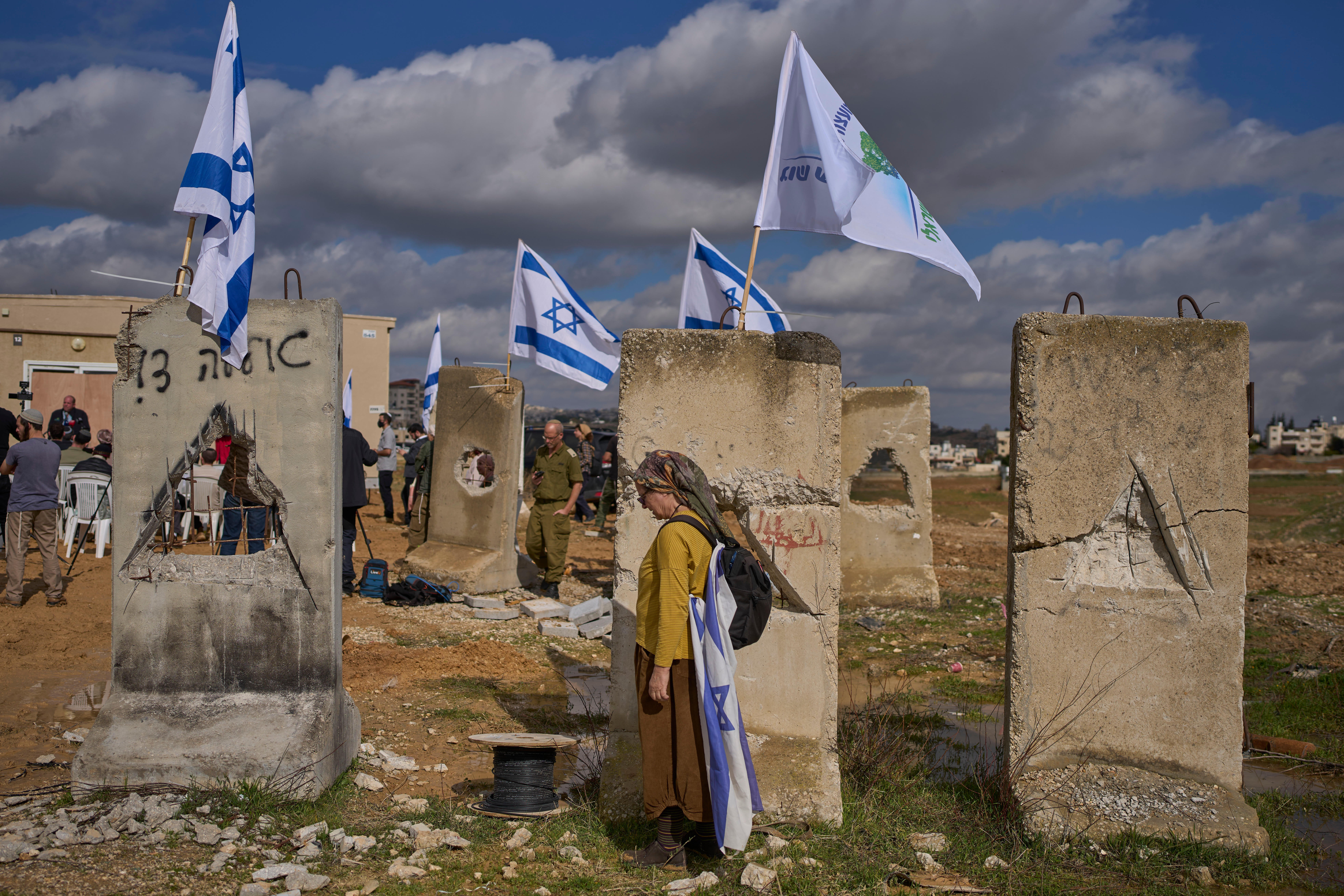 Settlers attend an inauguration ceremony for a newly-legalized Jewish settlement, Yatziv, adjacent to the Palestinian town of Beit Sahour, in the West Bank