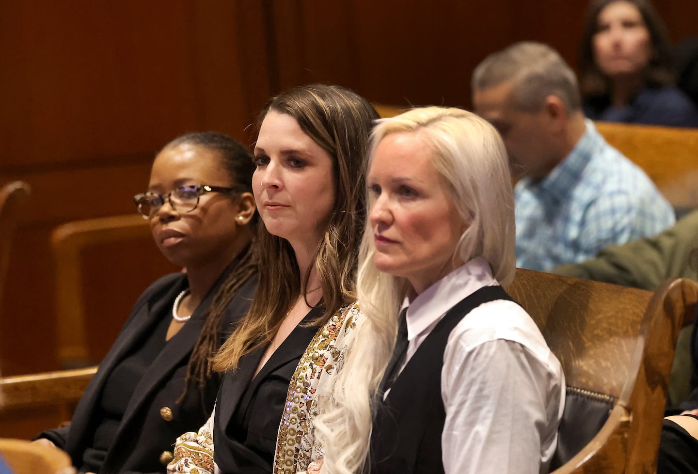 Drudys Ledbetter, Kristin Rogers, and Caroline Pineau waited to speak against the ballot initiative that would ban recreational pot sales at a State House hearing on March 23. Pineau is among four business owners who filed a lawsuit Wednesday aiming to block the question from reaching the November ballot.