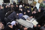 Relatives and friends of Amal Khalil, a veteran correspondent for the daily newspaper Al-Akhbar who was killed in a reported Israeli airstrike in southern Lebanon, mourn at her home in the village of Bisariyeh, on Thursday.