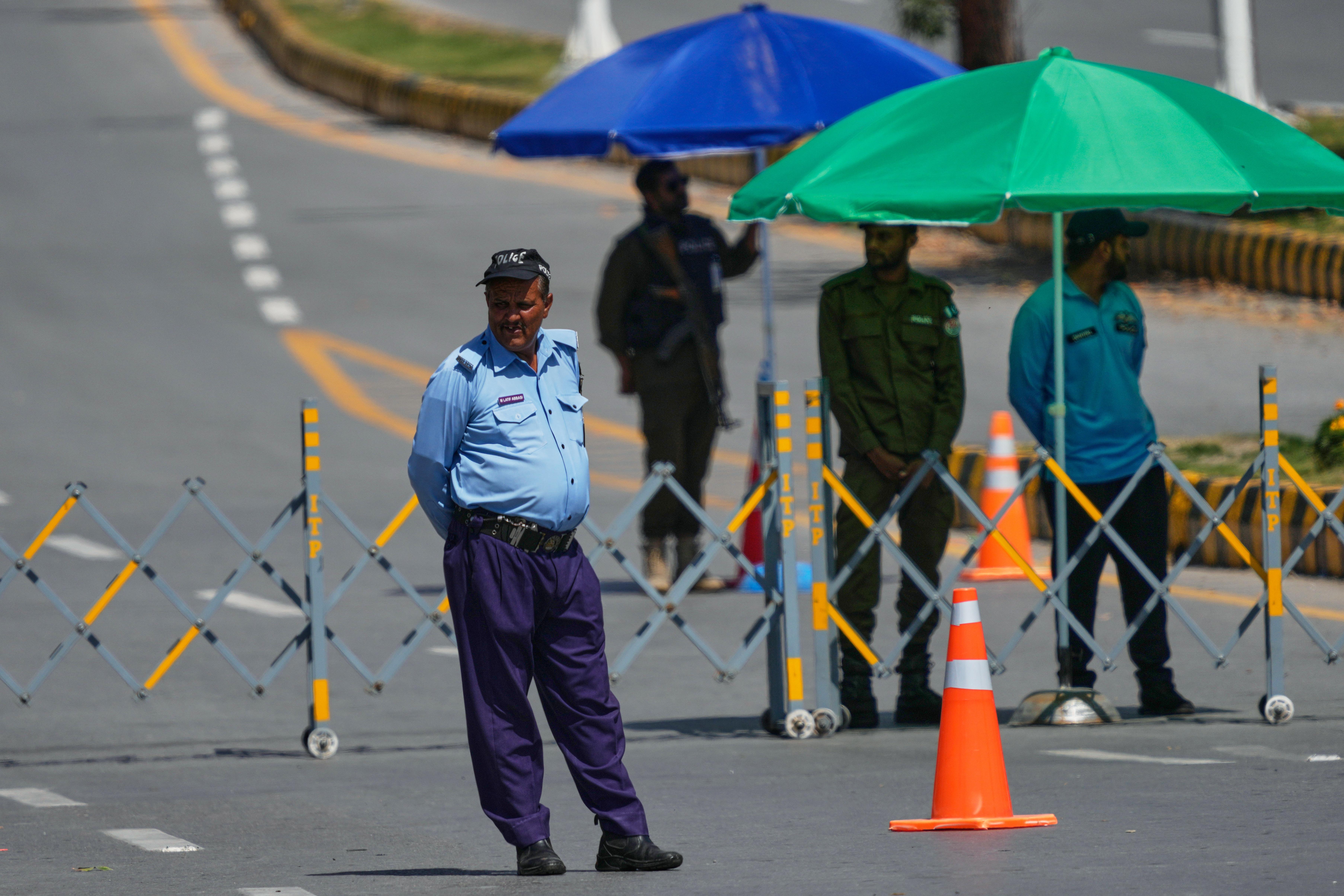 Police officers stand guard at a checkpoint to ensure security in Islamabad, Pakistan.