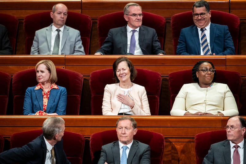 Elder Brian K. Taylor talks with outgoing Primary General President Susan H. Porter while she’s joined by Sister Amy A. Wright and Sister Tracy Y. Browning in the Conference Center during the Saturday afternoon session of the 196th Annual General Conference in Salt Lake City on Saturday, April 4, 2026.