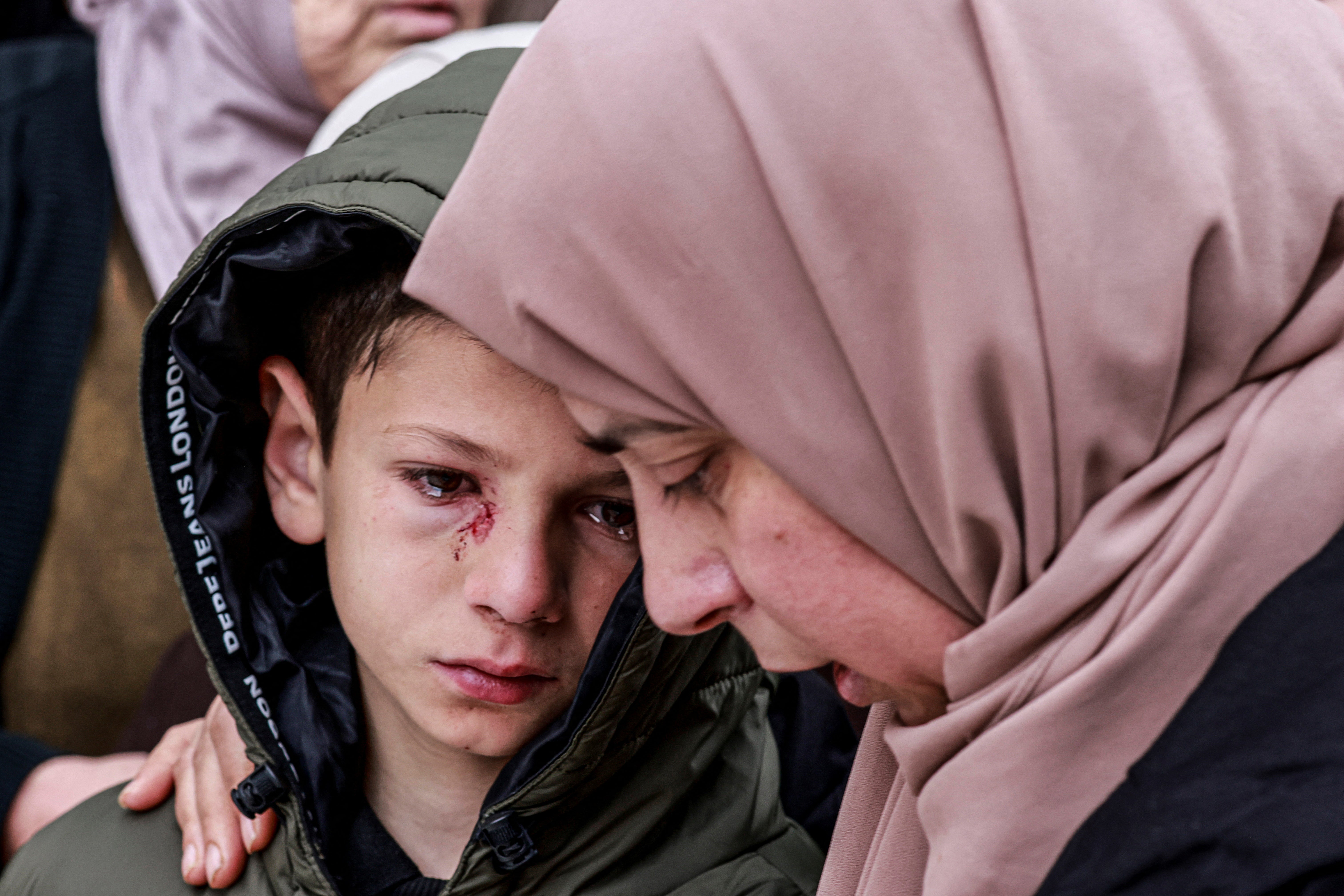 Mustafa, left, was injured when Israeli soldiers shot dead four members of a Palestinian family in the occupied West Bank in March