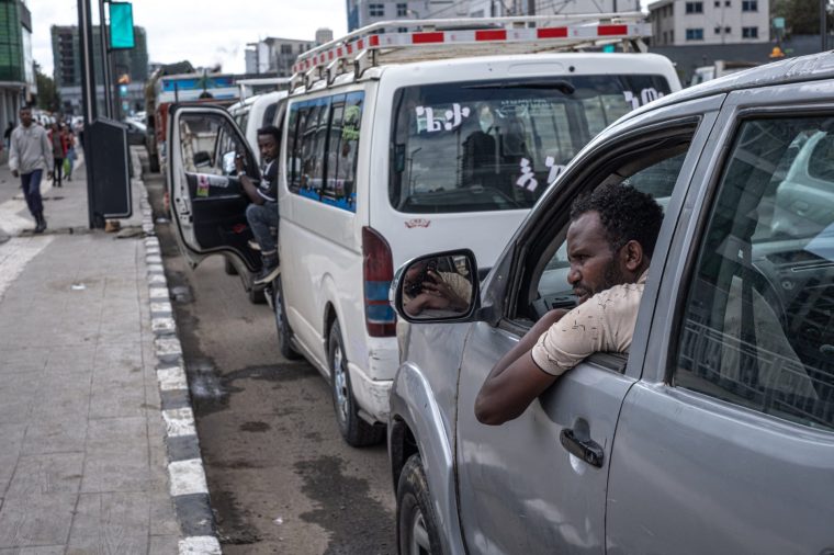 Vehicles line up along a street as drivers wait to refuel at a petrol station during a fuel shortage in Addis Ababa on March 27, 2026. Ethiopians said on March 27, 2026 they slept in their cars in hours-long queues for petrol as shortages caused by the Middle East war began to take their toll. The effective blockade of the Strait of Hormuz by Iran, through which a fifth of the world's oil and gas normally passes, has caused shortages in many countries. Ethiopia, a nation in the Horn of Africa with around 130 million people, is particularly vulnerable as it imports all its petrol, primarily from the Gulf. (Photo by Marco Simoncelli / AFP via Getty Images)