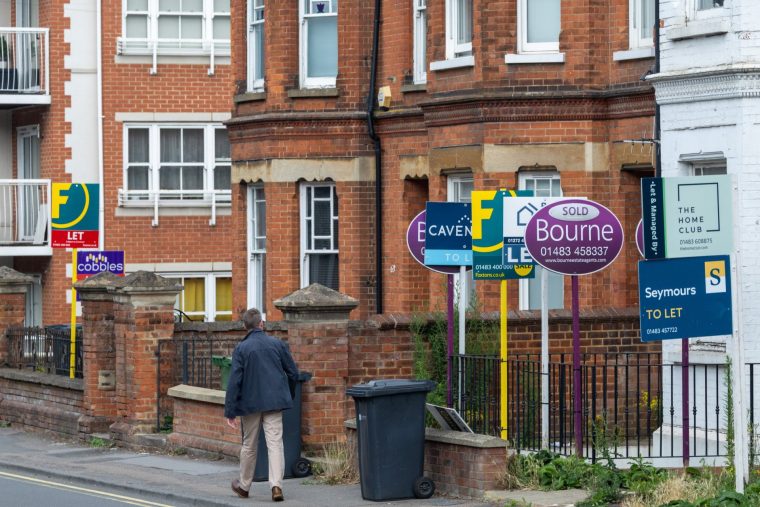 Estate agents 'for sale' and 'let' signs outside residential properties in Guildford, UK, on Monday, July 28, 2025. The number of UK home loans given the green light rose to a three-month high in June, as the housing market continued to shake off the impact of April's tax hike.??Photographer: Jason Alden/Bloomberg via Getty Images