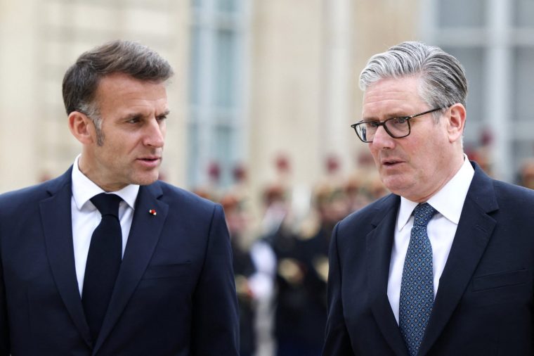 France's President Emmanuel Macron (L) speaks with Britain's Prime Minister Keir Starmer (R) as he leaves the Elysee Presidential Palace in Paris on April 17, 2026 following an international summit on efforts to reopen the Strait of Hormuz. French President Emmanuel Macron and UK Prime Minister Keir Starmer chair a meeting of allies to consider sending a multinational force to ensure security and free-flowing trade in the Strait of Hormuz once the current conflict between Iran and the US and Israel ends. Iran imposed the blockade on the critical shipping bottleneck as soon as the US and Israel launched the war against the Islamic republic on February 28, leading to a surge in global energy prices. Even with a shaky ceasefire in place, the US is now imposing its own blockade on Iranian ports. (Photo by Tom Nicholson / POOL / AFP via Getty Images)