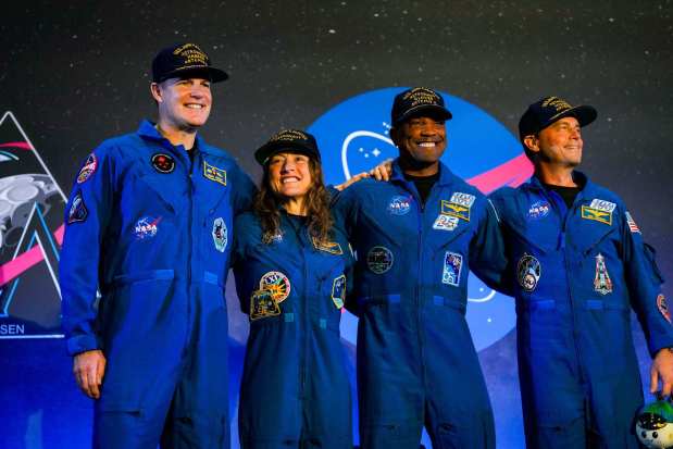 From left, Jeremy Hansen, Christina Koch, Victor Glover and Reid Wiseman, the Artemis II crew, are welcomed on stage during a news conference following their mission orbiting the moon, in Houston, on Saturday, April 11, 2026. (Raquel Natalicchio/Houston Chronicle via AP)