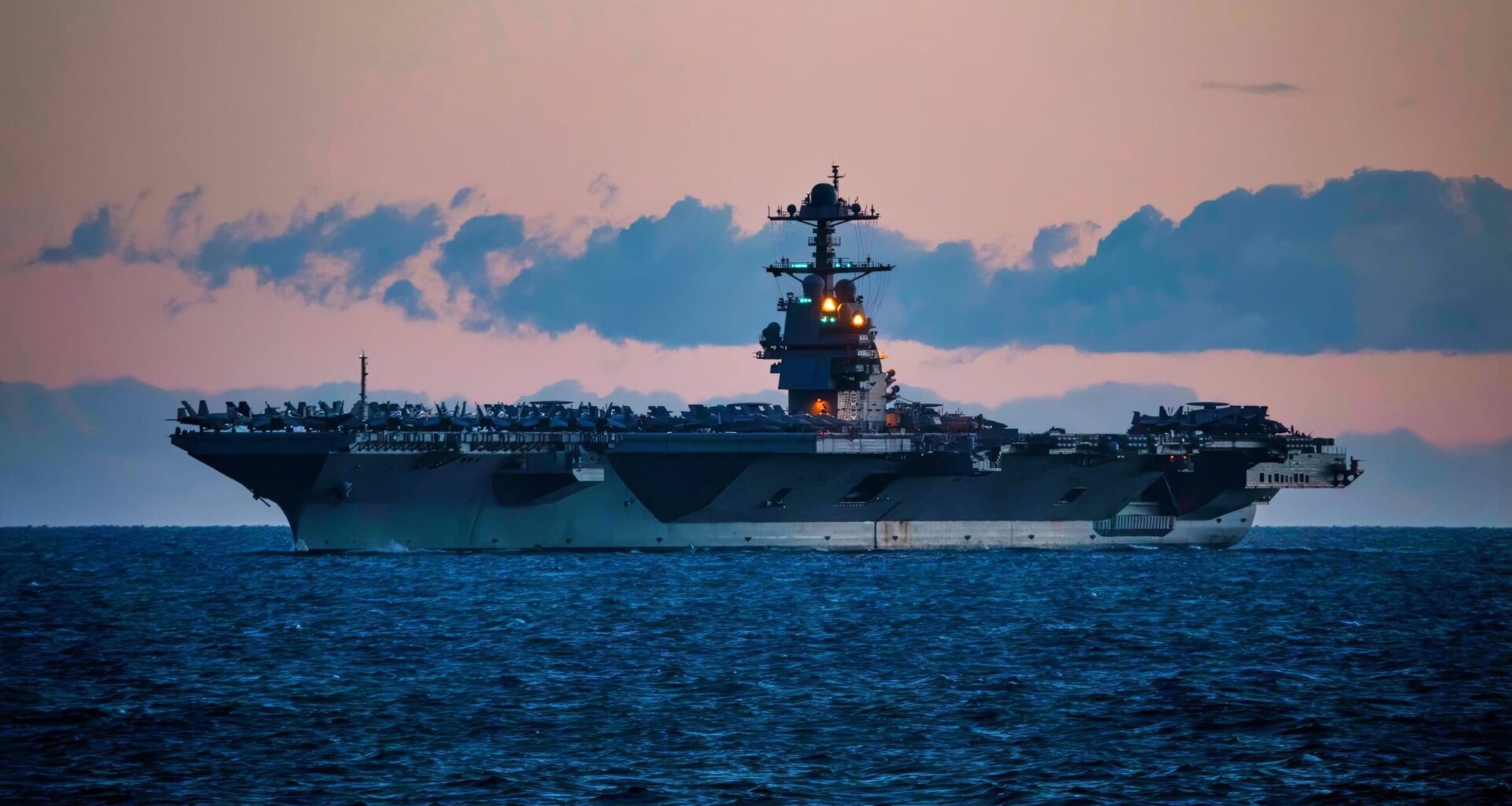 240105-N-LK647-1019 STRAIT OF GIBRALTAR (Jan. 5, 2024) A view from the Ticonderoga-class guided missile cruiser USS Normandy (CG 60) of the first-in-class aircraft carrier USS Gerald R. Ford (CVN 78), as the Ford Carrier Strike Group passes through the Strait of Gibraltar, Jan. 5, 2024. Normandy is part of the Gerald R. Ford Carrier Strike Group and is currently operating in the Mediterranean Sea, at the direction of the Secretary of Defense. The U.S. maintains forward-deployed, ready, and postured forces to deter aggression and support security and stability around the world. (U.S. Navy photo by Mass Communication Specialist 2nd Class Malachi Lakey)