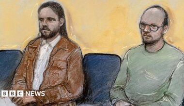 Court artist drawing of Jamie Varley (left) sitting in the dock at Preston Crown Court with long dark hair and a beard wearing a white shirt and brown jacket with co-accused John McGowan-Fazakerley who is nearly bald with a short dark beard and glasses and a green sweatshirt