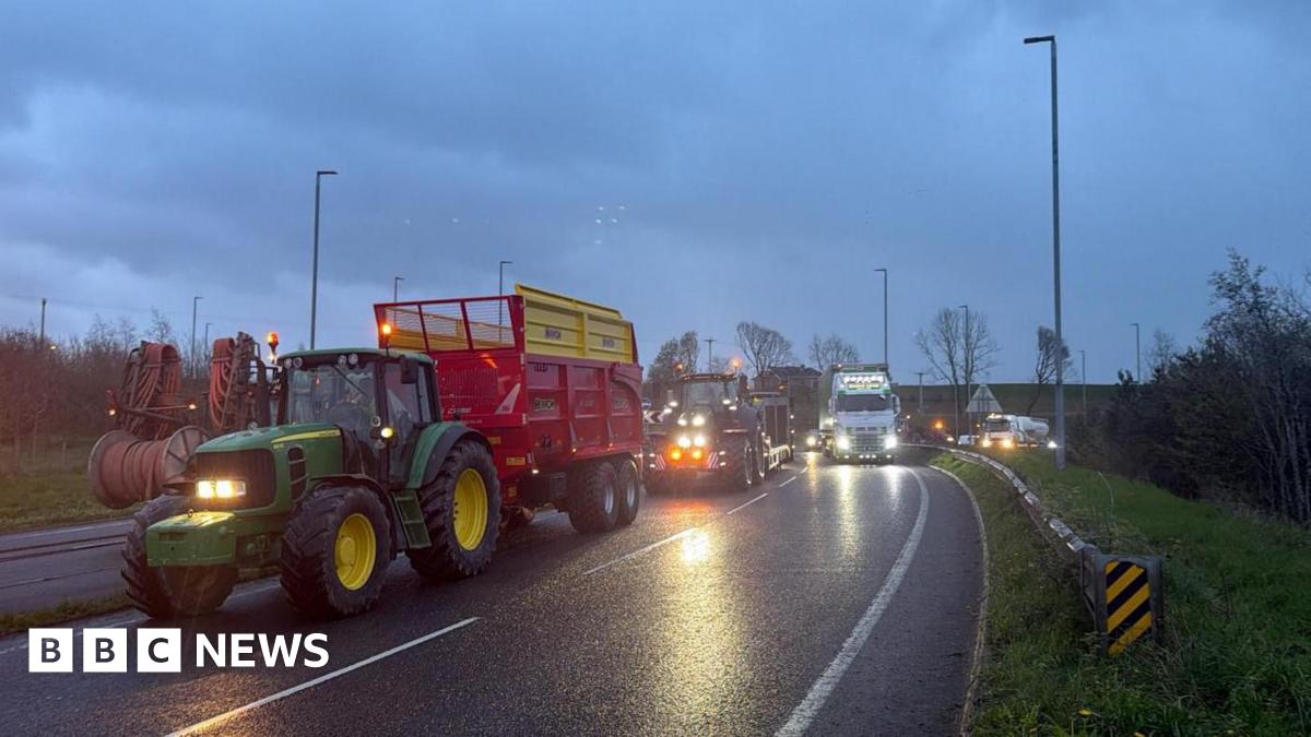 Undercover footage of a man in a suit, wearing glasses, in a hotel lobby.