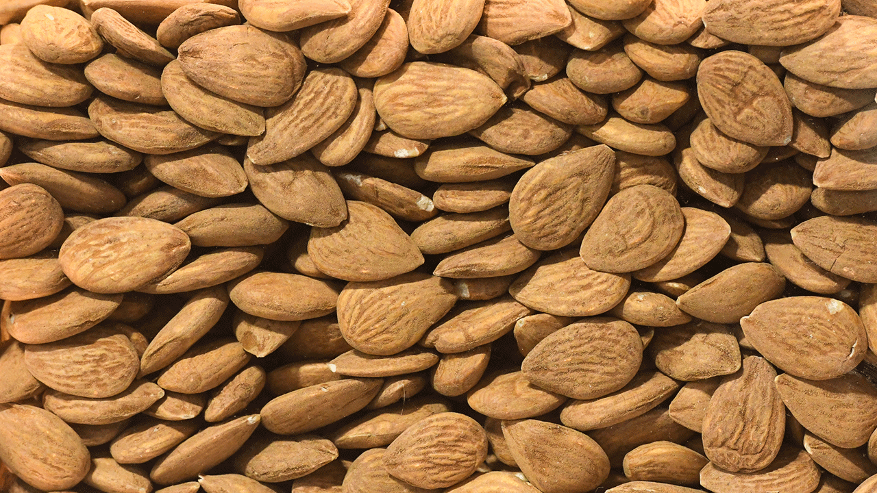 Pile of almonds on a white surface