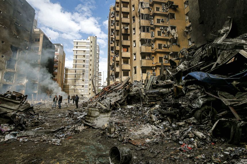 People inspect the aftermath of Israeli strikes on Beirut on Thursday.
