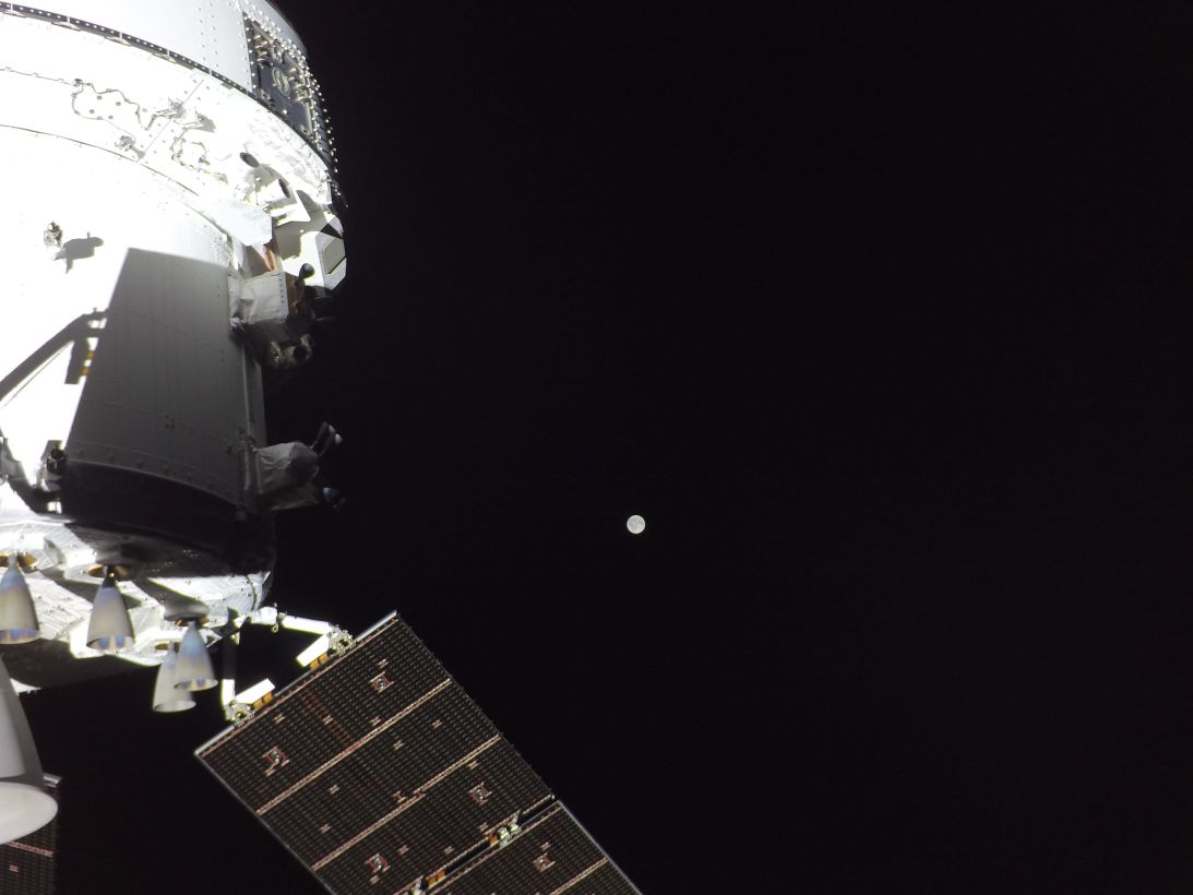 A camera on Orion's solar array wings shows the moon in the distance on the mission's second day.
