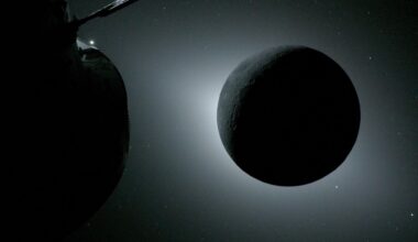 The Moon, backlit by the Sun during a solar eclipse, is photographed by NASA’s Orion spacecraft on April 6, 2026, during the Artemis II mission. Orion is visible in the foreground on the left. Earth is reflecting sunlight at the left edge of the Moon, which is slightly brighter than the rest of the disk. The bright spot visible just below the Moon’s bottom right edge is Saturn. Beyond that, the bright spot at the right edge of the image is Mars.