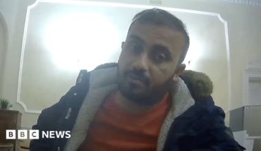 Zahid Hasan Akhand, a bearded man wearing a fleece jacket and jumper and sitting at a desk, in a picture taken by an undercover reporter