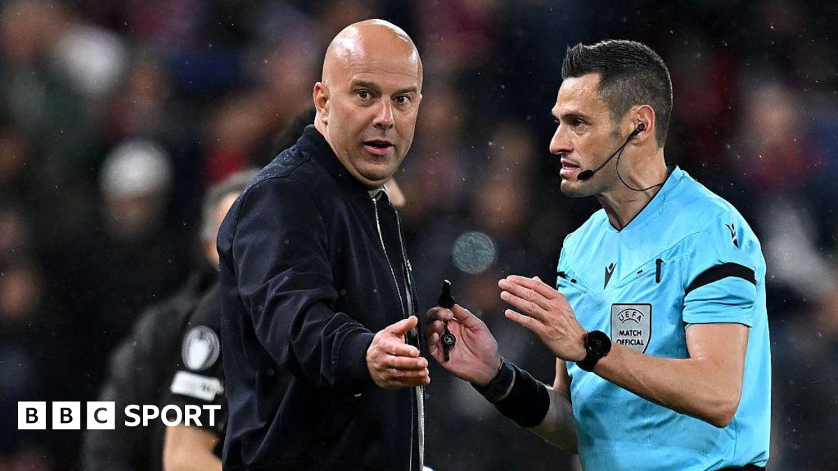Liverpool manager Arne Slot speaks to referee Maurizio Mariani during the Champions League quarter-final second leg against Paris St-Germain