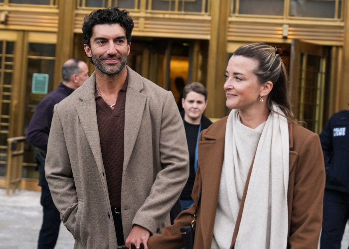 Couple in brown coats outside a building, relating to Blake Lively lawsuit statement causing fan frenzy.