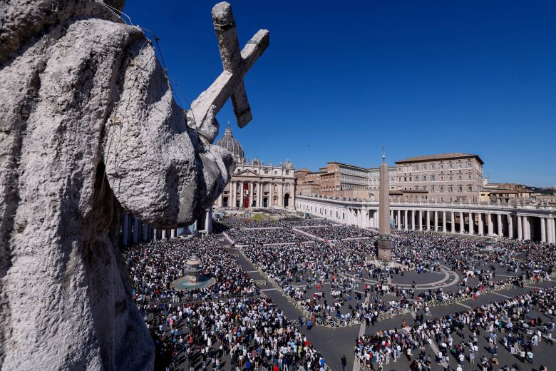 People attend the Easter Mass led by Pope Leo XIV in St. Peter's Square at the Vatican, on Sunday morning.