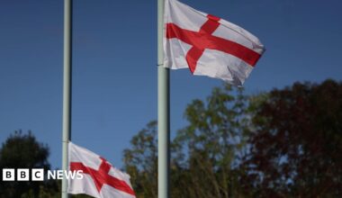 Flags of St George fly on lamp posts in London.