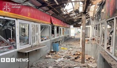 Photo provided by the Ukrainian prosecutor's office showing badly damaged indoor market area - a corridor with kiosks on either side with broken windows, and metal and glass strewn across the floor.