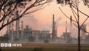 An oil refinery with smoke seen billowing out from several areas