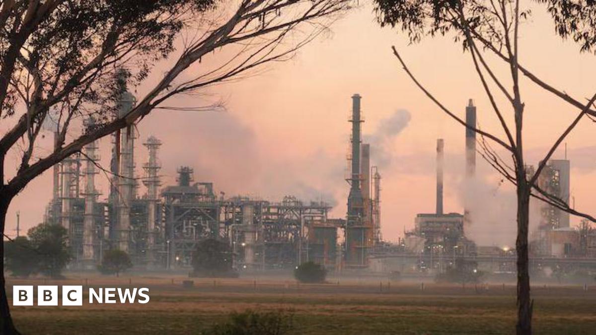 An oil refinery with smoke seen billowing out from several areas