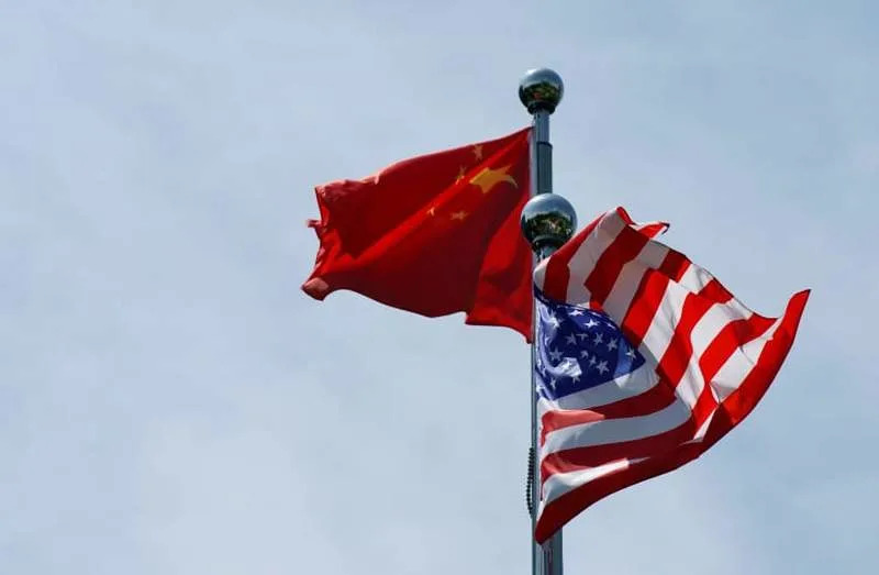 Chinese and US flags flutter before a trade meeting in Shanghai, China July 30, 2019 (credit: REUTERS/ALY SONG)