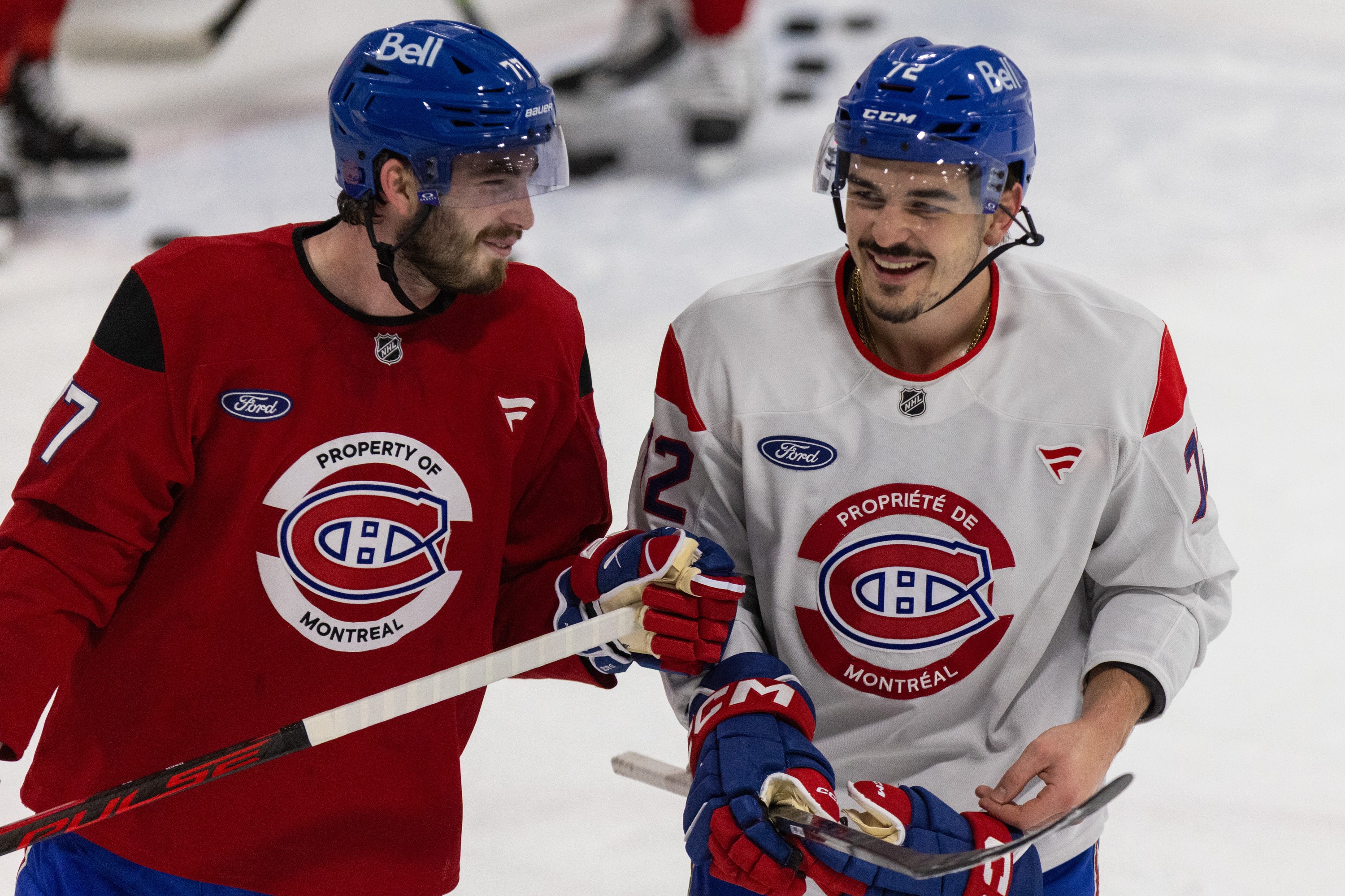 Canadiens forward Kirby Dach, left, and defenceman Arber Xhekaj during a light moment at the end of practice in Brossard on Thursday.